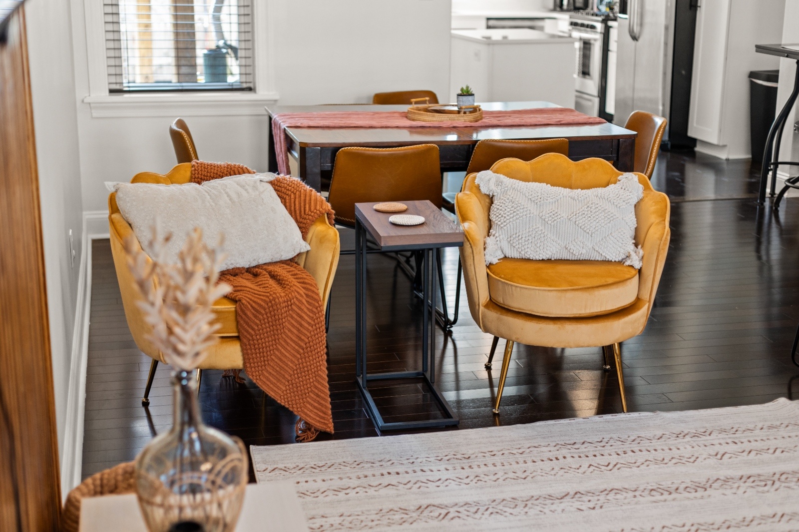 Dining area inside Luxury on Lemon Lancaster Airbnb with mustard accent chairs and table set for group gatherings during a bachelorette stay.