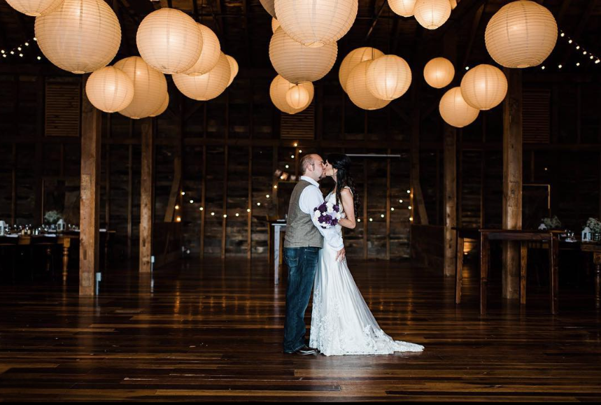 Country Barn Weddings Reception Barn Couple sharing a first dance inside Country Barn Weddings in Lancaster County