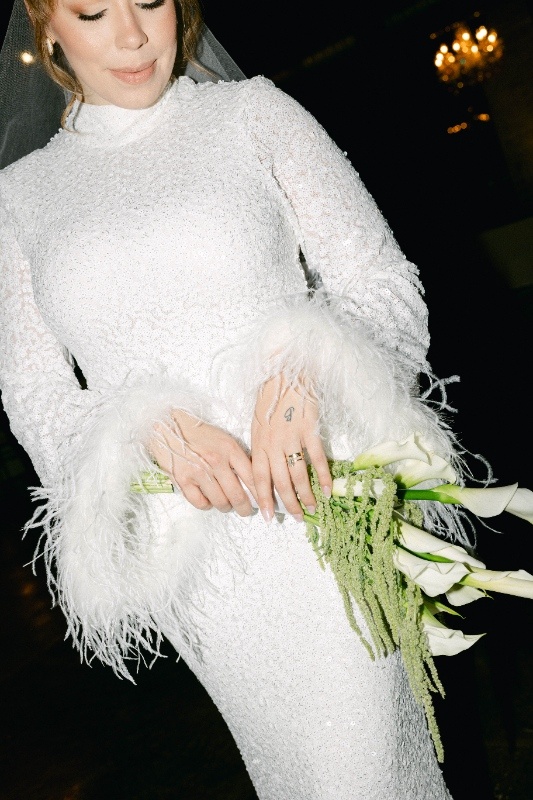 Statement Bridal Dress Bride in statement bridal dress with texture, sparkles and feathers.