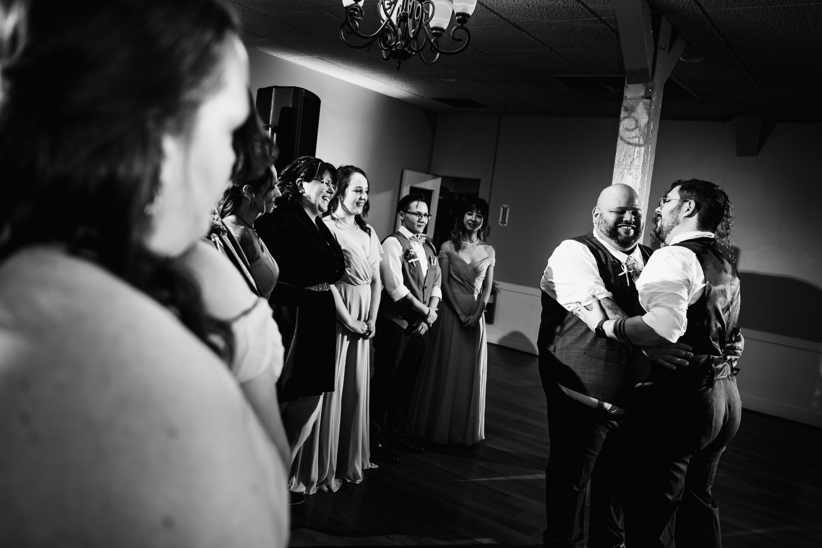 Emotional First Dance Wedding Photo Couple shares an emotional first dance surrounded by family and friends during their Pennsylvania wedding reception.