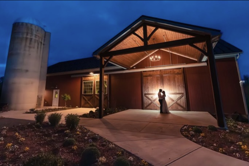 Promise Farm Wedding Venue Couple standing beneath the covered entrance at Promise Farm wedding venue in Manheim, Pennsylvania