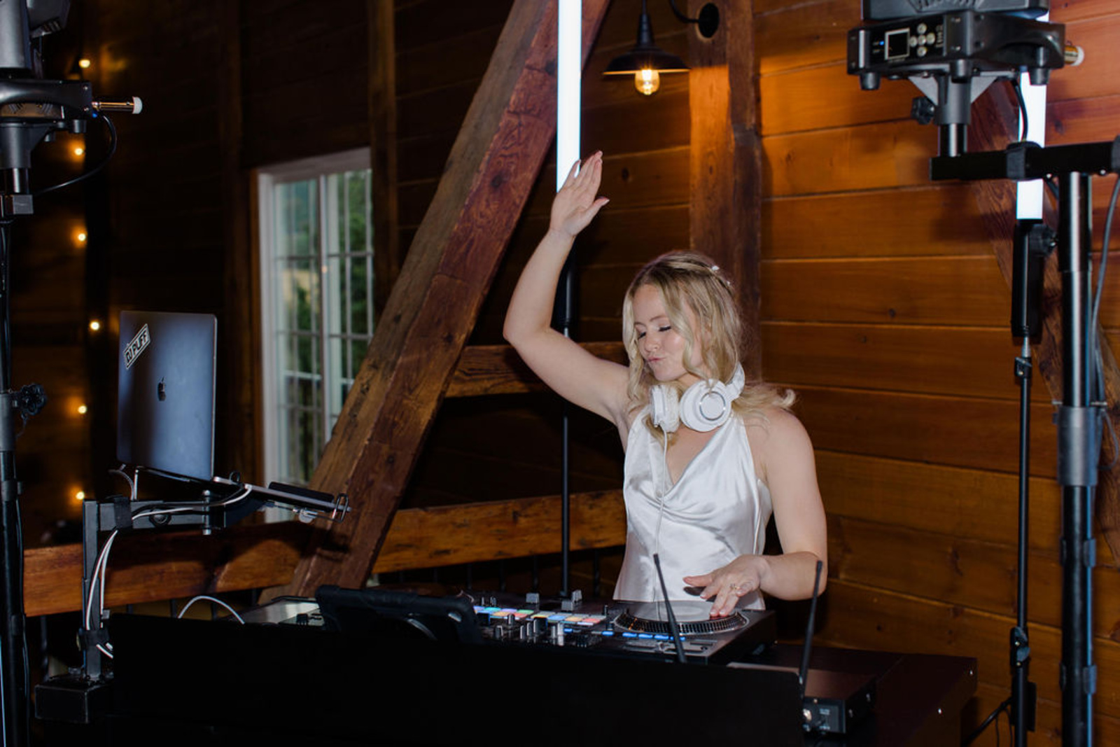 Bride DJing at Historic Ashland Reception Bride wearing a satin reception dress while DJing during the wedding reception inside Historic Ashland’s barn venue.