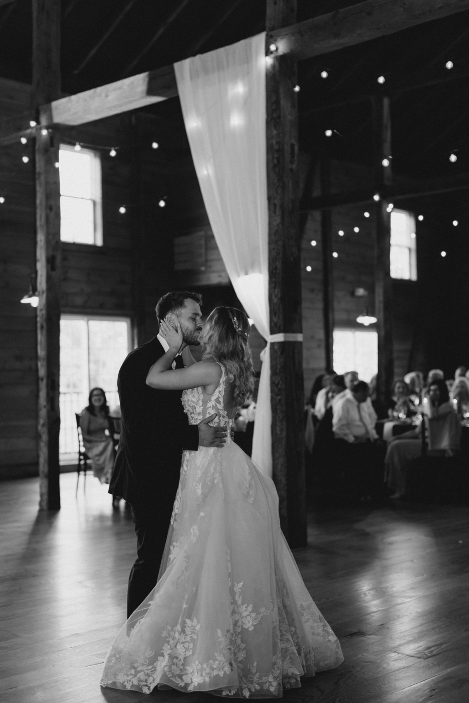 irst Dance Inside Historic Ashland Lodge Bride and groom sharing a romantic first dance inside Historic Ashland’s warmly lit barn reception space.