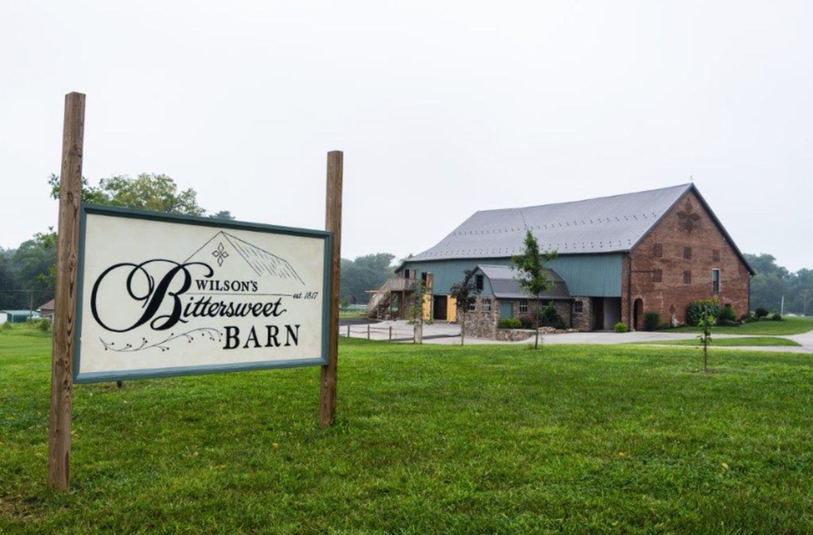 Wilson’s Bittersweet Barn Wedding Venue in New Oxford PA Wilson’s Bittersweet Barn wedding venue in New Oxford, PA, featuring its historic brick barn and venue sign.