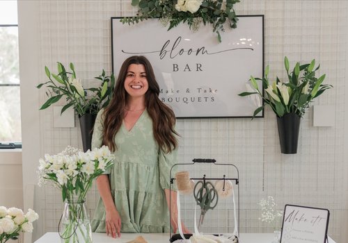 Selah Floral Studio owner standing at a custom wedding bloom bar in Howard, PA.